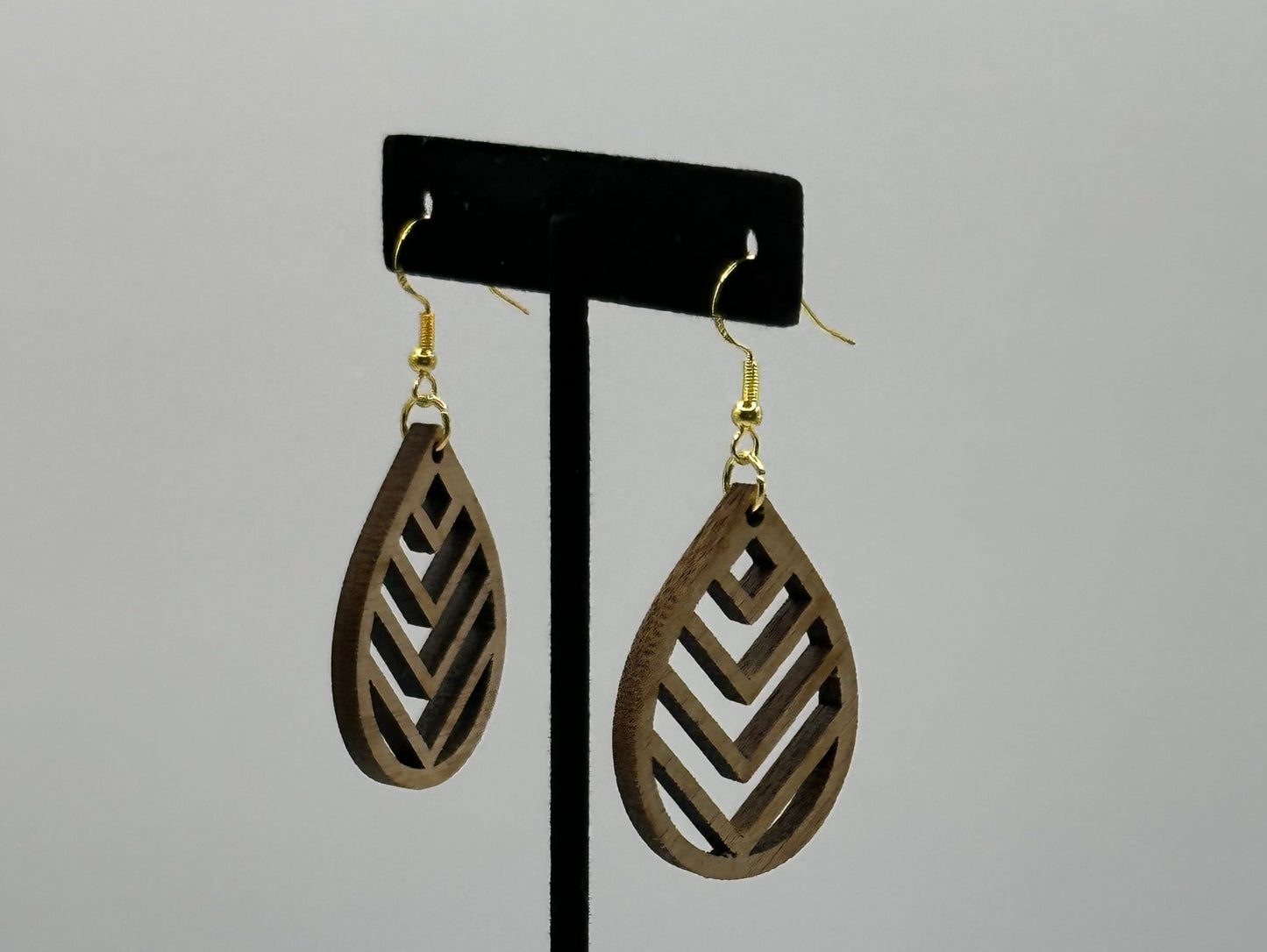 Walnut teardrop earrings with golden finish 925 sterling silver French hooks.